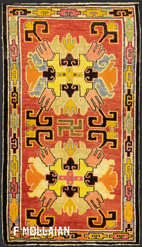 Hand-knotted Tibetan antique rug with geometric medallion design, featuring swastika motifs on a light red background, bordered by multicolored cloud patterns, 150x85 cm.