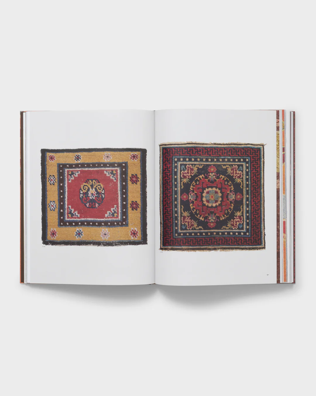 Open book displaying two Tibetan carpets, showcasing traditional hand-knotted designs with intricate patterns and vibrant colors.
