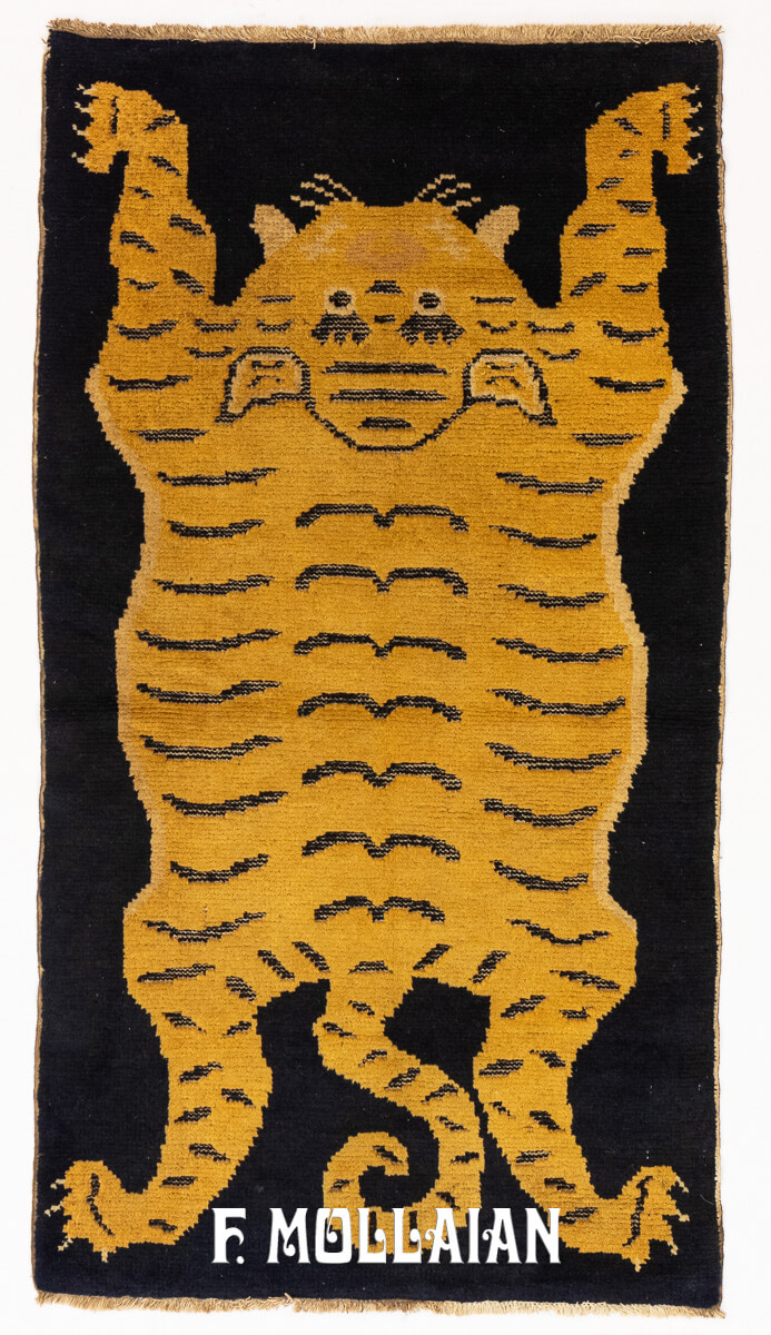 Antique Tibetan tiger rug featuring a stylized golden tiger with black stripes on a contrasting black background, handwoven in traditional Tibetan craftsmanship